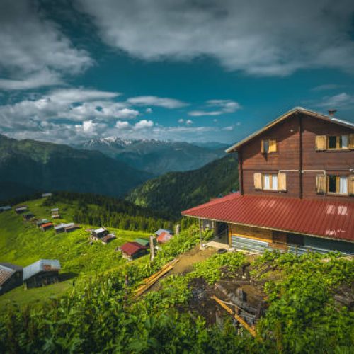 Wooden pension anf beautful nature landscape view at Pokut Highland life in Çamlıhemşin, Rize in Black sea region of Turkey on sunny and foggy  summer morning